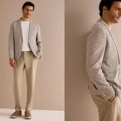 Stilvolles Standesamt Outfit Mann: Mann trägt hellgraues Sakko, weißes T-Shirt und beige Hose. Perfekt für den besonderen Tag.