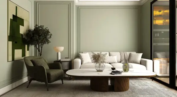 Ein stilvolles japandi style wohnzimmer mit einem beigen Sofa, einem grünen Sessel, einem ovalen Couchtisch und einem abstrakten Bild.