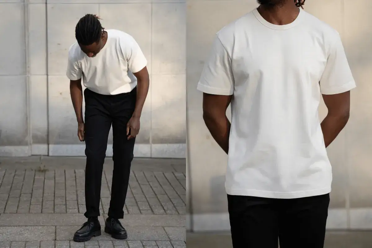 Mann in weißem T-Shirt, cloud dancer farbe, und schwarzer Hose.