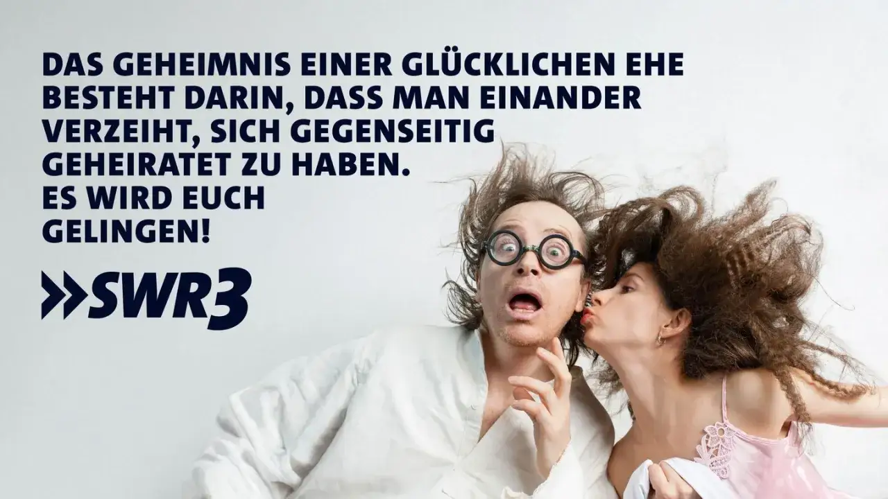 Ein Mann mit Brille und zerzaustem Haar wird von einer Frau geküsst. Der lustige Spruch